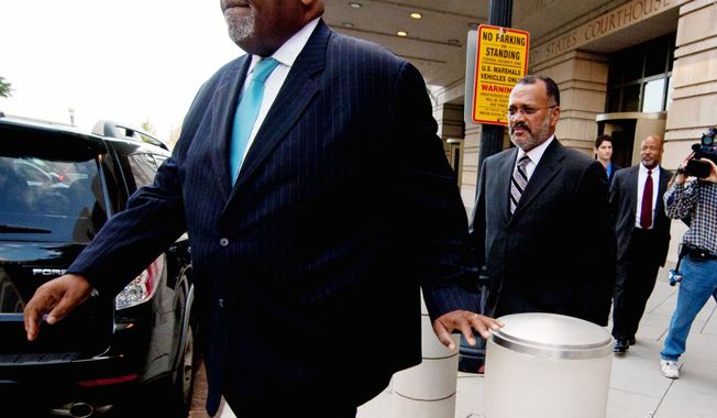 Howard L. Brooks, a former campaign aide for Mayor Vincent C. Gray, leaves U.S. District Court after being sentenced Wednesday to 24 months of probation for lying to federal agents about money he gave to a Gray challenger to stay in the 2010 primary race and bash the sitting mayor, Adrian M. Fenty. (Craig Bisacre/The Washington Times)