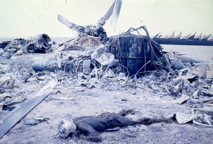 The remains of severely burned bodies of U.S. Marines are pictured amidst the wreckage of U.S. aircraft, including helicopters and giant transporters, after an abortive Commando-style raid into Iran aimed at freeing hostages being held at the U.S. Embassy. The desert site is in Eastern Iran at Desht-E-Kavir, some 500 kilometers from Tehran. At least eight U.S. servicemen died in the mission on April 24, 1980. (AP Photo)