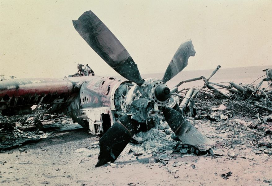 The burned out wreckage of a U.S. aircraft lies in the desert some 300 miles south of Tehran after the abortive commando-style raid into Iran, April 1980, aimed at freeing the American hostages being held in Tehran. The rescue mission fell apart when several helicopters failed and a helicopter and C141 transport plane collided. At least 8 U.S. servicemen died in the mission. (AP Photo)