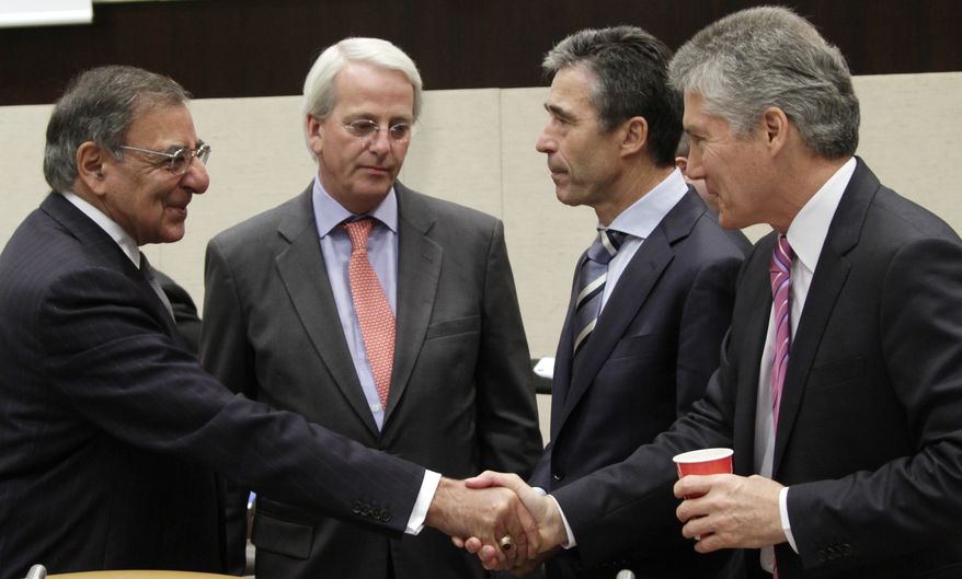 U.S. Secretary of Defense Leon E. Panetta (left) shakes hands with Australian Defense Minister Stephen Smith (right) as U.S. Ambassador to NATO Ivo Daalder (second from left) and NATO Secretary-General Anders Fogh Rasmussen look on during a round-table meeting of NATO defense ministers at the alliance's headquarters in Brussels on Wednesday, Oct. 10, 2012. (AP Photo/Virginia Mayo)