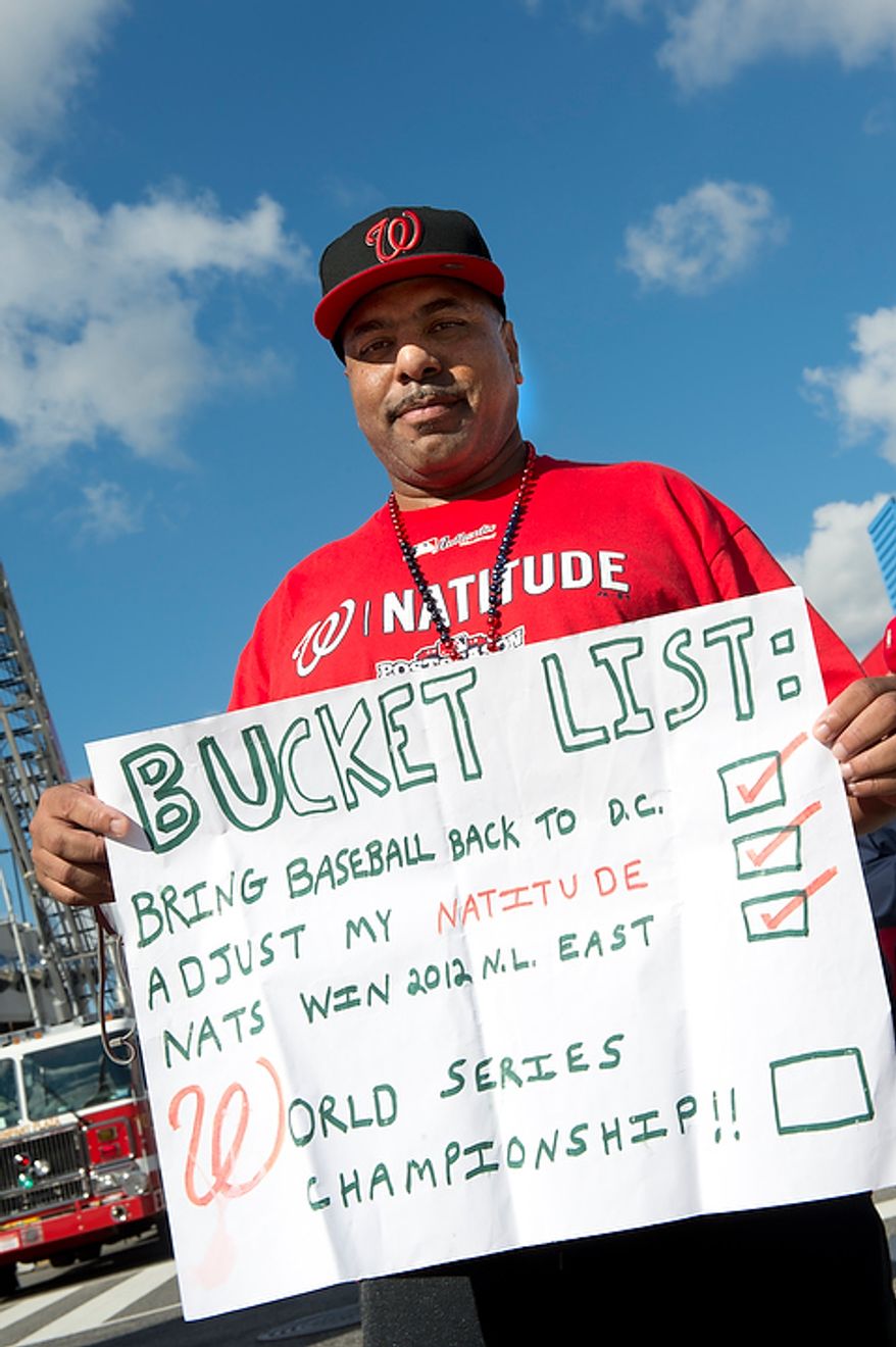 Shellie Bowers Jr. of Washington, D.C. holds his "Bucket List" sign outside of Nationals Park before the first home game in the National League Division Series on Wednesday, Oct. 10, 2012. (Barbara L. Salisbury/The Washington Times)