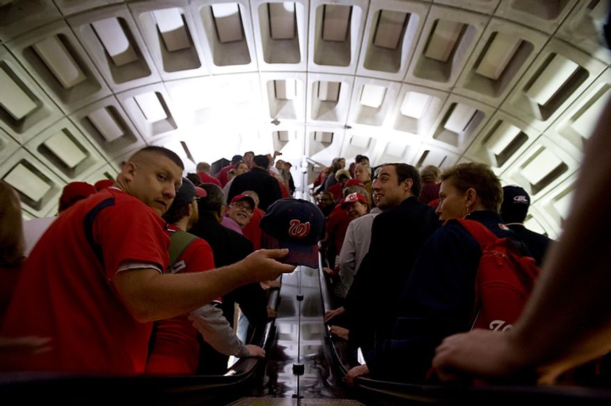 Washington Nationals fans head up the escalator at the Navy Yard station on their way to the ballpark for the first home game in the National League Division Series on Wednesday, Oct. 10, 2012. (Barbara L. Salisbury/The Washington Times)