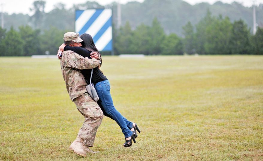 Army PFC Fabian Castrillon hugs his fiancee Marivel Penalea, right, during a welcome home ceremony for 100 soldiers from the Army's 1st Battalion, 30th Infantry Regiment, Wednesday, Oct. 10, 2012 at Fort Stewart, Ga. Overall about 2,200 soldiers from Fort Stewartís 3rd Infantry Division have deployed to Afghanistan this year. (AP Photo/Stephen Morton)