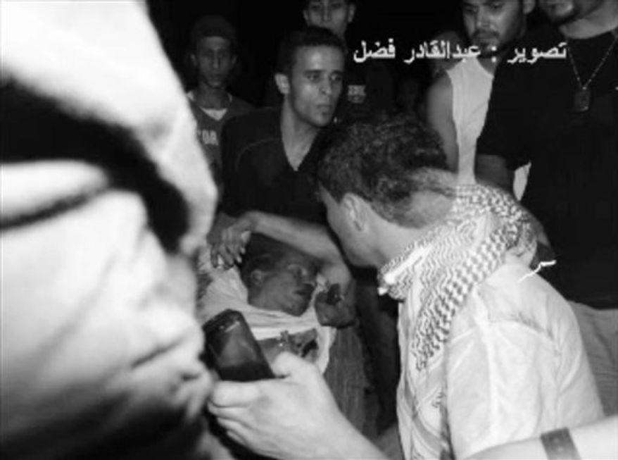 This still image included in a video obtained by the Associated Press from Fahd al-Bakoush, a freelance videographer and activist, which has been authenticated based on its contents and other AP reporting, shows the body of U.S. Ambassador J. Christopher Stevens being moved by Libyan civilians trying to rescue him after gunmen and protesters rampaged through the U.S. Consulate in Benghazi, Libya, on Tuesday, Sept. 11, 2012. (AP Photo/Fahd al-Bakoush)