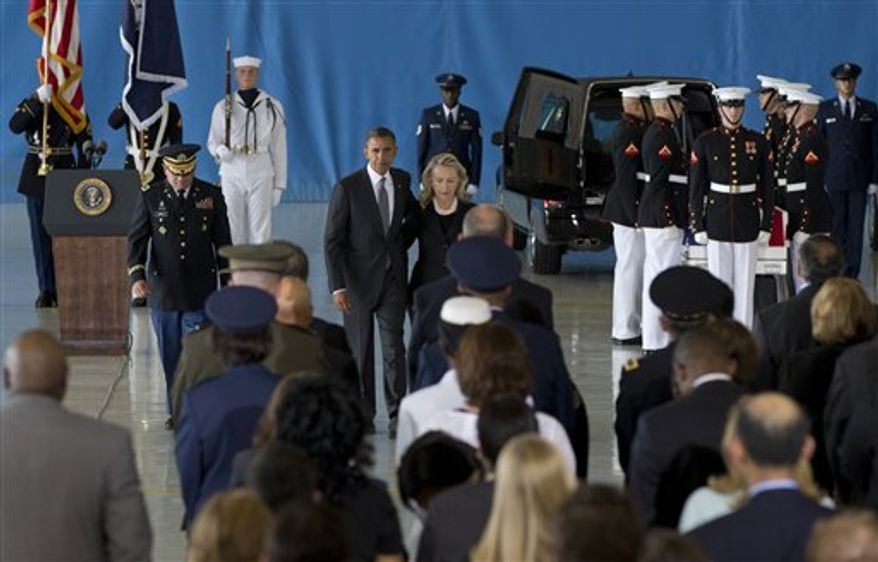 President Obama and Secretary of State Hillary Rodham Clinton walk back to their seats after speaking during the Transfer of Remains Ceremony on Friday, Sept. 14, 2012, at Andrews Air Force Base in suburban Washington. The ceremony marked the return to the United States of the remains of the four Americans killed at the U.S. Consulate in Benghazi, Libya, on Sept. 11. (AP Photo/Carolyn Kaster)