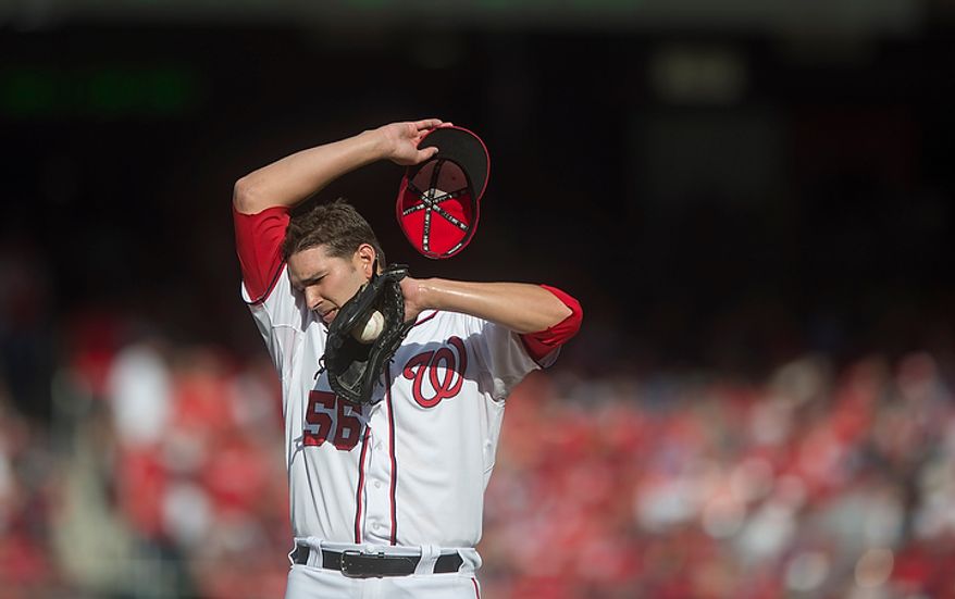 Nationals' relief pitcher Christian Garcia wipes his brow following a conference on the mound in the top of the seventh inning as the Washington Nationals host the St. Louis Cardinals for Game 3 of the National League Division Series at Nationals Park in Washington, D.C., Wednesday, Oct. 10, 2012. (Rod Lamkey Jr./The Washington Times)