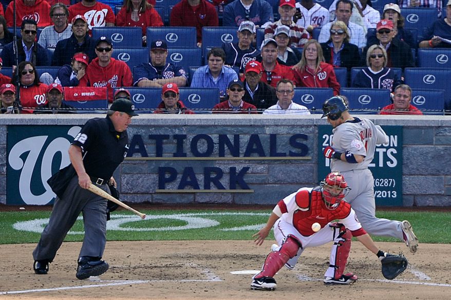 St. Louis Cardinals catcher Yadier Molina (R) scores before the ball gets to Washington Nationals catcher Kurt Suzuki in the top of the 6th inning of Game 3 of the National League Division Series at Nationals Park, Washington, D.C.., Oct. 10, 2012. (Preston Keres/Special to The Washington Times)