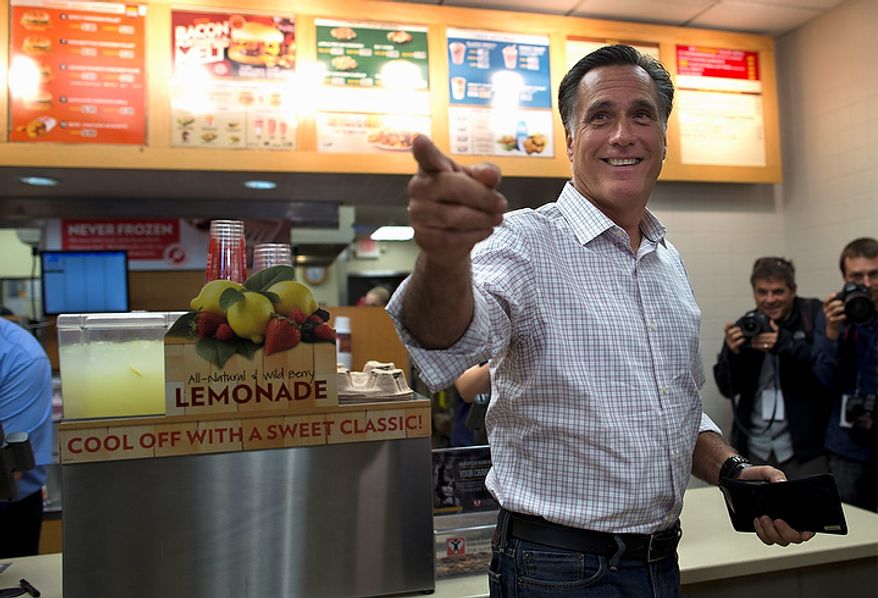 Republican presidential candidate Mitt Romney asks his staff for their orders after stopping at a Wendy's restaurant on Tuesday, Oct. 9, 2012, in Cuyahoga Falls, Ohio. (AP Photo/Evan Vucci)