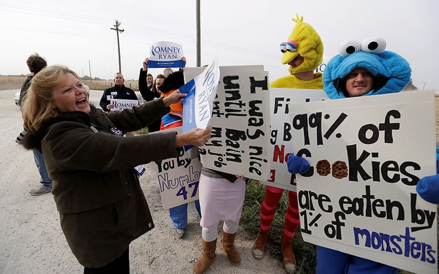 Romney supporter Jayne Whetstone (left) of Menlo, Iowa, talks with members of Iowa Citizens for Community Improvement Action Fund who are dressed in "Sesame Street" costumes outside a campaign stop for Republican presidential candidate Mitt Romney at the Koch family farm on Tuesday, Oct. 9, 2012, in Van Meter, Iowa. (AP Photo/Charlie Neibergall)