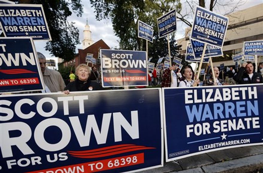 Supporters of Republican incumbent Sen. Scott Brown and Democratic challenger Elizabeth Warren hold signs outside Symphony Hall in Springfield, Mass., Wednesday Oct. 10, 2012, prior to their third debate. (AP Photo/Elise Amendola)