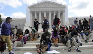 Supporters of the University of Texas rally outside the U.S. Supreme Court in Washington on Wednesday, Oct. 10, 2012, as the high court takes up a challenge to the university&#39;s program that considers race in some college admissions. (AP Photo/Susan Walsh)