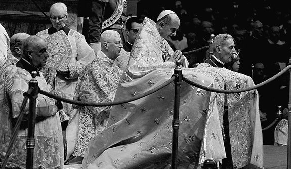 Pope Paul VI kneels in prayer in St. Peter&#39;s Basilica in the Vatican on Sept. 29, 1963, during the opening ceremony for the second phase of the Ecumenical Council of the Roman Catholic Church. At left is Cardinal Alberto di Jorio, a member of the Vatican Curia.  At right is Monsignor Enrico Dante, prefect of Vatican ceremonies. (AP Photo)