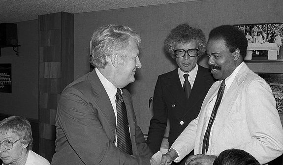 United States Ambassador to the United Nations, Donald McHenry, right, shakes hands with Bob Anders, one of the Americans secreted out of Iran by former Canadian Ambassador to Iran Ken Taylor, center, in New York, May 30, 1980. The three attended a dinner before New York Yankees Canadian Night at Yankee Stadium.  (AP Photo/Richard Drew)