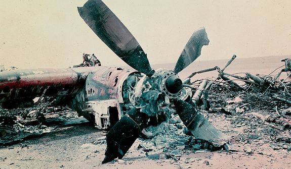 The burned out wreckage of a U.S. aircraft lies in the desert some 300 miles south of Tehran after the abortive commando-style raid into Iran, April 1980, aimed at freeing the American hostages being held in Tehran.  The rescue mission fell apart when several helicopters failed and a helicopter and C141 transport plane collided.  At least 8 U.S. servicemen died in the mission.  (AP Photo)