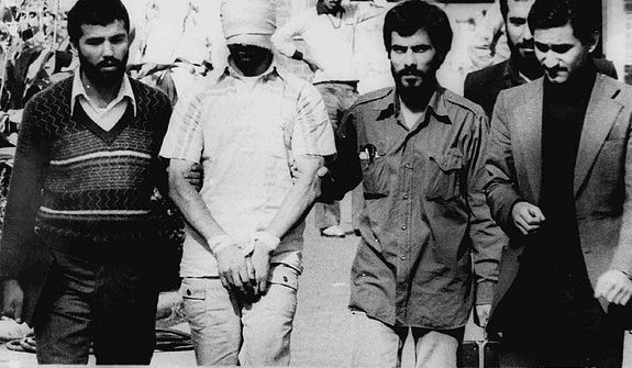 FILE - In this Nov. 9, 1979 file photo, one of the hostages being held at the U.S. Embassy in Tehran is displayed blindfolded and with his hands bound to the crowd outside the embassy. Fifty-two of the hostages endured 444 days of captivity. On the 30th anniversary of their release, at least 10 former hostages have said they will join each other for a reunion hosted by the U.S. Military Academy at West Point on Jan. 20, 2011. (AP Photo, File)