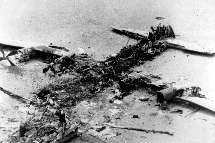 The scorched wreckage of an American C-130 Cargo aircraft lies in the Iranian desert of Dasht-E-Kavir, approximately 500 kilometers from Tehran, Iran on April 27, 1980. The mission to free 50 American hostages from the U.S. Embassy in Tehran was aborted due to equipment failure. The plane collided with a U.S. helicopter and eight servicemen were killed. (AP Photo)