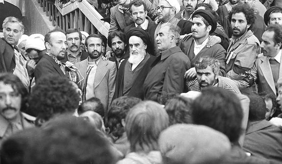 Ayatollah Ruhollah Khomeini, center, is surrounded by followers, Feb. 1, 1979, after his arrival at Mehrabad Airport after 14 years of exile.  (AP Photo)