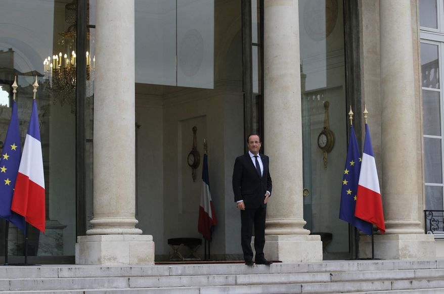 French President Francois Hollande wait for Microsoft founder Bill Gates and, and Irish performer Bono, unseen, before a meeting at the Elysee Palace, in Paris, Wednesday, Oct. 10, 2012. (AP Photo/Christophe Ena)