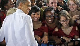 **FILE** President Obama stops for a photo with members of the Vox Harmonia Visual and Performing Arts Academy Salem High School during a Sept. 27, 2012, campaign event at Farm Bureau Live in Virginia Beach, Va. (Associated Press)
