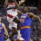 Washington Wizards guard Jordan Crawford (15) goes up for a shot over New York Knicks center Henry Sims (25) during the first quarter of an NBA preseason basketball game in Washington, Thursday, Oct. 11, 2012. The Knicks defeated the Wizards 108-101. (AP Photo/Ann Heisenfelt)