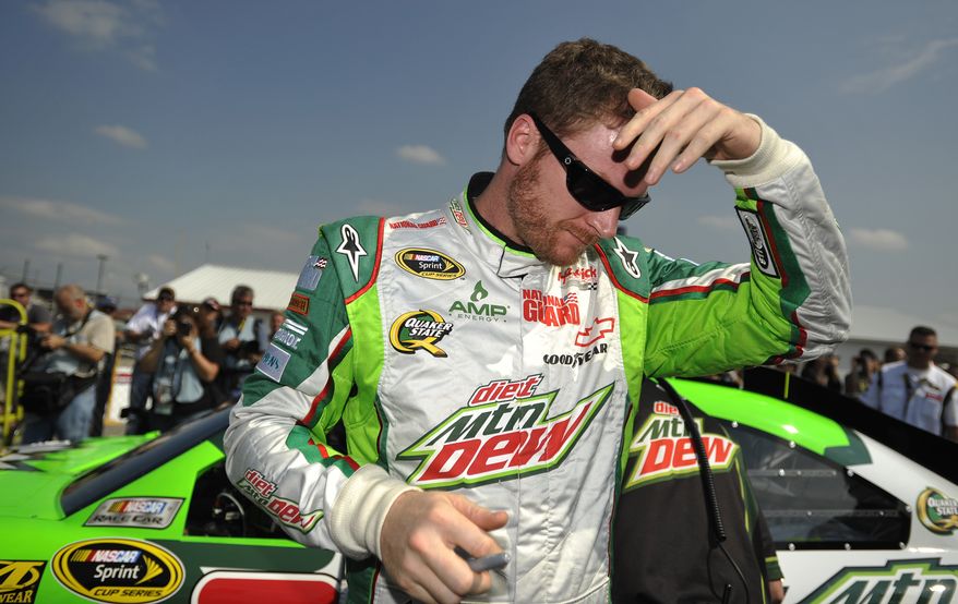 NASCAR driver Dale Earnhardt Jr., wipes his brow Oct. 6, 2012, after qualifying at Talladega Superspeedway in Talladega, Ala. The drivers were qualifying for the Sunday running of the NASCAR Sprint Cup Series auto race. (Associated Press)
