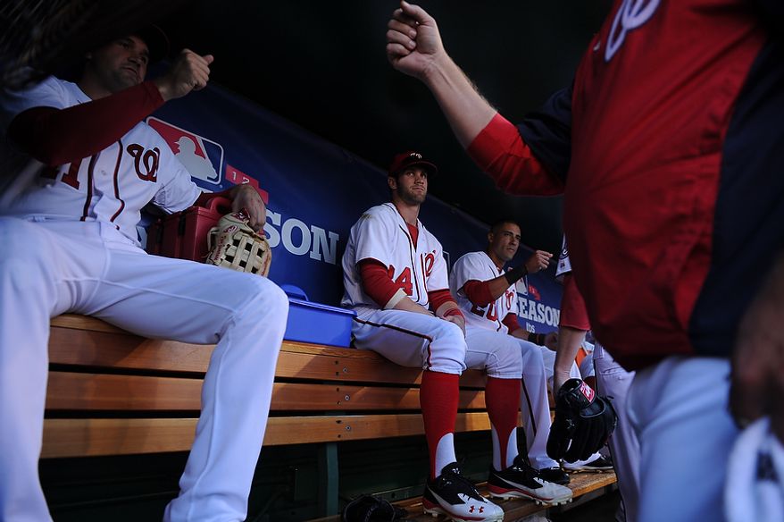 Bryce Harper watches Nationals third baseman Ryan Zimmerman fist bump teammates before the start of Game 4 of the National League Division Series between the Washington Nationals and the St. Louis Cardinals at Nationals Park, Thursday, October 11, 2012. (Andrew Harnik/The Washington Times)