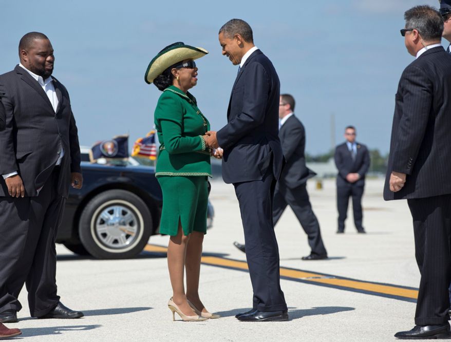 President Obama is greeted Oct. 11, 2012, by Rep. Frederica Wilson (center), Florida Democrat, and Florida state Rep. Dwight Bullard (left) as he steps off of Air Force One at Miami International Airport in Miami. (Associated Press)