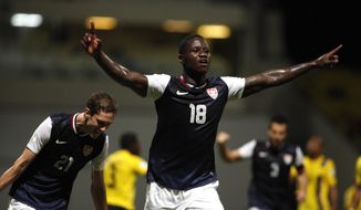 US Eddie Johnson, center, celebrates after scoring against Antigua and Barbuda during a 2014 World Cup qualifying soccer match in St. John, Antigua and Barbuda, Friday, Oct. 12, 2012. (AP Photo/Ricardo Arduengo)