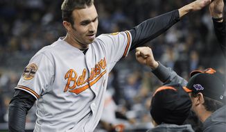 Baltimore Orioles&#39; J.J. Hardy celebrates with teammates after driving in a run during the 13th inning of Game 4 of the American League division baseball series against the New York Yankees Thursday, Oct. 11, 2012, in New York. The Orioles won 2-1. (AP Photo/Bill Kostroun)