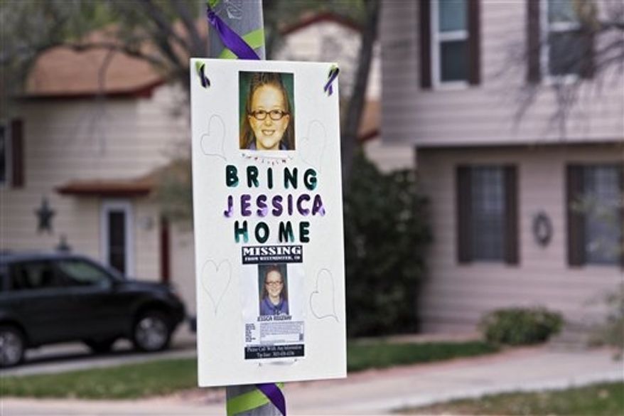 A missing person sign is posted on a lamp post near the home of 10-year-old Jessica Ridgeway where police continue to search for the missing girl in Westminster, Colo., on Wednesday, Oct. 10, 2012. The youngster has been missing since she left her home Friday morning on her way to school. (AP Photo/Ed Andrieski)