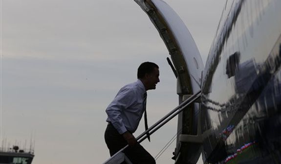 Republican presidential candidate and former Massachusetts Gov. Mitt Romney boards his campaign plane in Fletcher, N.C., Friday, Oct. 12, 2012. (AP Photo/Charles Dharapak)