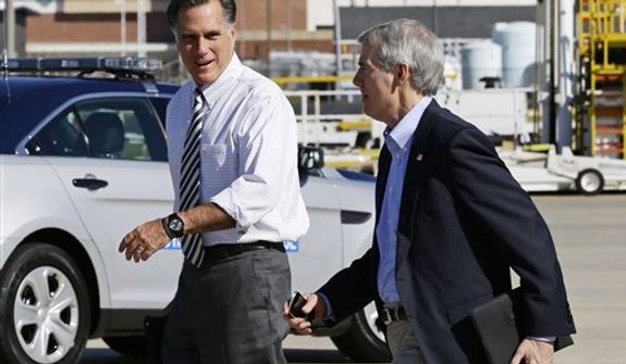 Republican presidential candidate, former Massachusetts Gov. Mitt Romney walks with Sen. Rob Portman, R-Ohio, as he arrives in Richmond, Va., Friday, Oct. 12, 2012. (AP Photo/Charles Dharapak)
