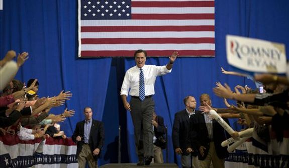 Republican presidential candidate, former Massachusetts Gov. Mitt Romney waves as he arrives for a campaign rally at the U.S. Cellular Center on Thursday, Oct. 11, 2012 in Asheville, N.C.  (AP Photo/ Evan Vucci)