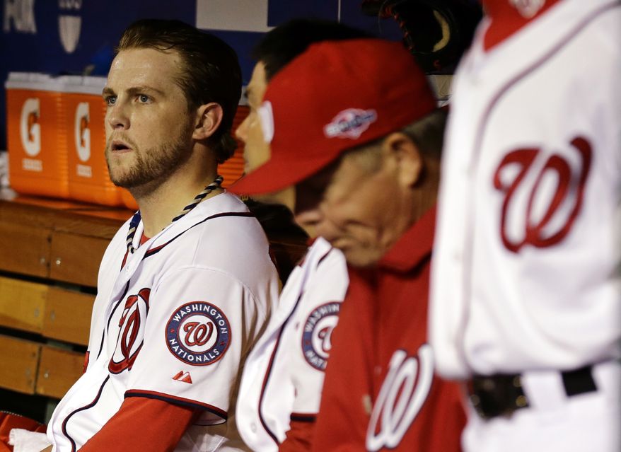 Washington Nationals relief pitcher Drew Storen, left, looks on from the dugout after Game 5 of the National League division baseball series against the St. Louis Cardinals on Saturday, Oct 13, 2012, in Washington. St. Louis won 9-7. (AP Photo/Alex Brandon)