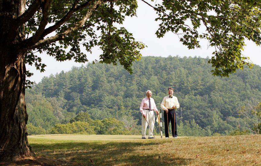 Lewis Keller Sr. (left) and Bill Sharp stand on the ninth hole at Oakhurst links course in West Virginia, which will be bought by the nearby Greenbrier resort. (The Associated Press)