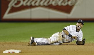 New York Yankees shortstop Derek Jeter reacts after injuring himself in the 12th inning of Game 1 of the American League championship series against the Detroit Tigers early on Sunday, Oct. 14, 2012, in New York. (AP Photo/Paul Sancya )