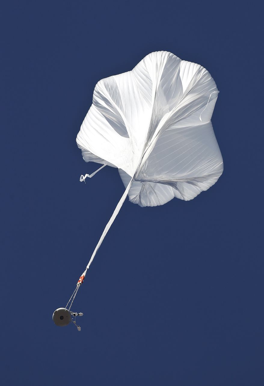 The capsule and attached helium balloon carrying Felix Baumgartner lifts off as he attempts to break the speed of sound during a jump from an altitude of 120,000 feet on Sunday, Oct. 14, 2012, in Roswell, N.M. (AP Photo/Ross D. Franklin)