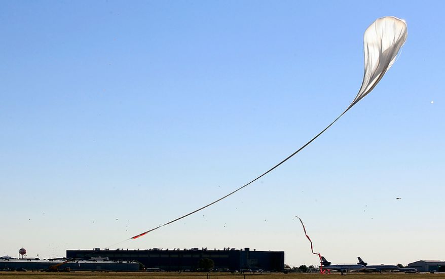 The capsule and attached helium balloon carrying Felix Baumgartner lifts off as he attempts to break the speed of sound with his own body by jumping from a space capsule lifted by a helium balloon on Oct. 14, 2012, in Roswell, N.M. Baumgartner plans to jump from an altitude of 120,000 feet, an altitude chosen to enable him to achieve Mach 1 in free fall, which would deliver scientific data to the aerospace community about human survival from high altitudes. (Associated Press)