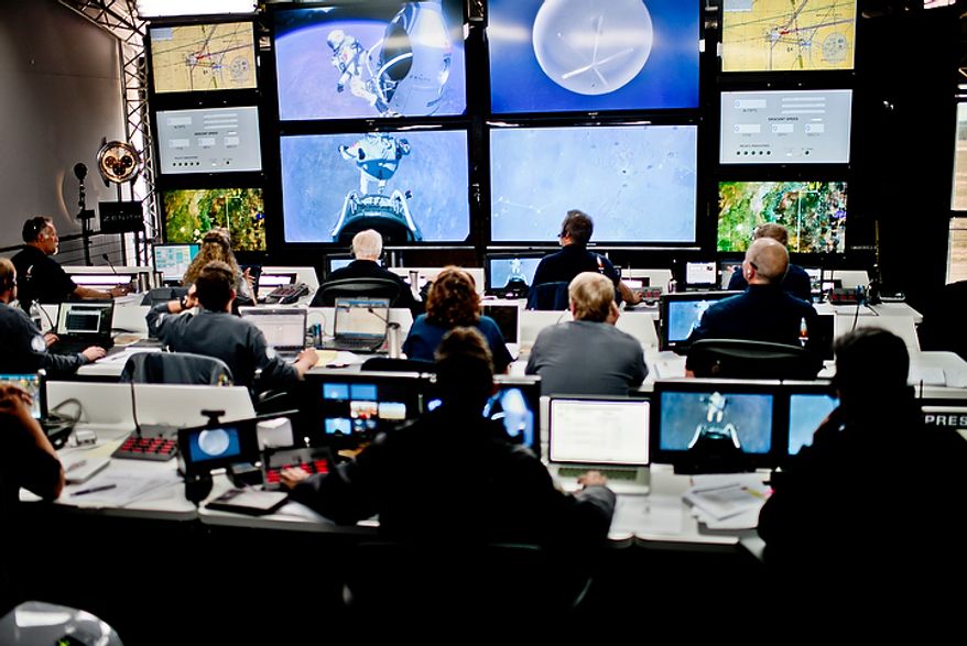 In this photo provided by Red Bull, crew members at the mission control watch the jump of pilot Felix Baumgartner of Austria in Roswell, N.M., on Oct. 14, 2012. Baumgartner came down safely in the eastern New Mexico desert minutes about nine minutes after jumping from his capsule 128,097 feet, or roughly 24 miles, above Earth. (Associated Press/Red Bull Stratos, Joerg Mitter)