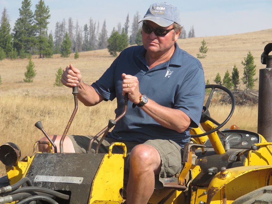 Montana Gov. Brian Schweitzer operates a backhoe on Wednesday, Sept. 19, 2012, as he clears a stream under a bridge he built on his ranch in Marysville, Mont., about 45 miles from the capital, Helena. (AP photo/Matt Gouras)