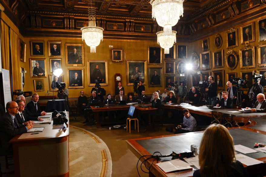 Journalists listen as (from left) Per Krusell, Staffan Normark, Peter Gardenfors and Tore Ellingsen of the Swedish Royal Academy of Sciences announce the winners of the Nobel Memorial Prize in Economic Sciences in Stockholm on Monday, Oct. 15, 2012. Alvin Roth of Harvard University and Lloyd Shapley of the University of California at Los Angeles won the prize "for the theory of stable allocations and the practice of market design." (AP Photo/Scanpix Sweden, Henrik Montgomery)