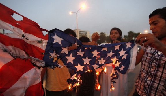 Libyan followers of the Ansar al-Shariah Brigades burn the U.S. flag during a protest in front of the Tibesti Hotel in Benghazi, Libya, on Friday, Sept. 14, 2012. Small teams of U.S. special operations forces arrived at American embassies throughout North Africa to set up a new counterterrorist network months before militants killed the U.S. ambassador in Libya at the U.S. Consulate in Benghazi on Sept. 11, but officials say the network was too new to stop that attack. (AP Photo/Mohammad Hannon)