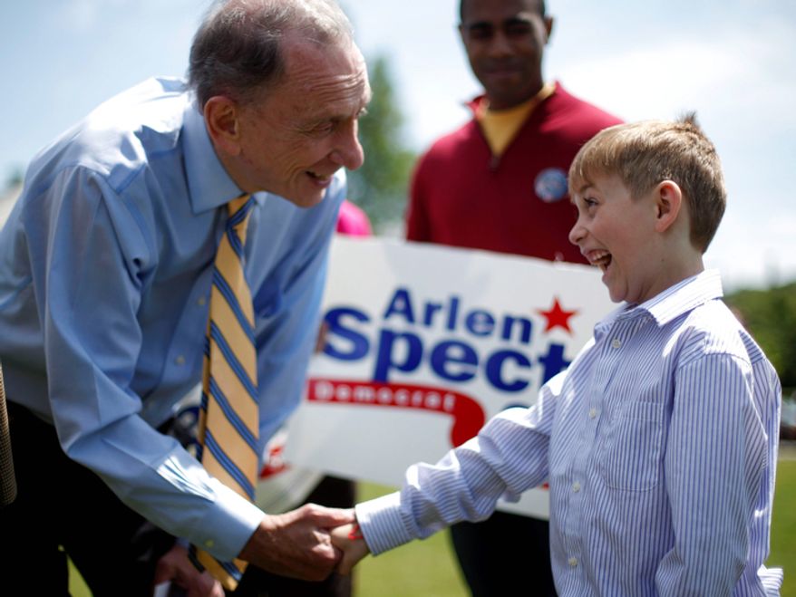 **FILE** Sen. Arlen Specter, Pennsylvania Democrat, shakes hands with Victor Cazzone, 7, of Exton, Pa., during a May 15, 2010, campaign rally at Gateway Park in Coatesville, Pa. (Associated Press)