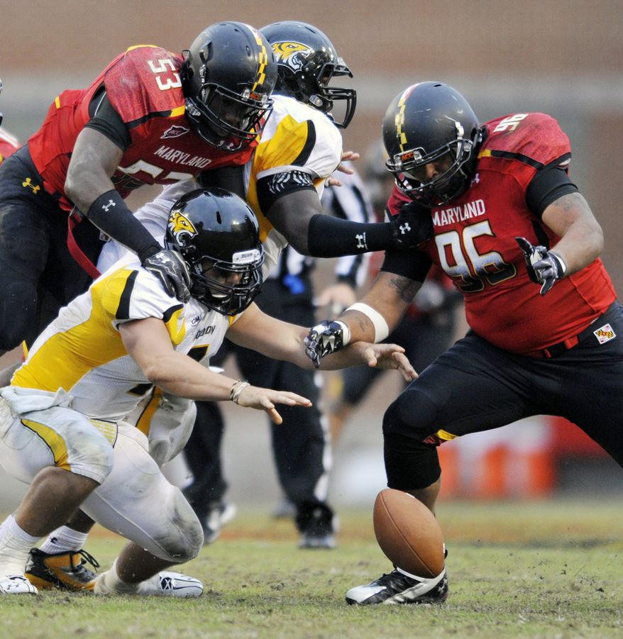Towson quarterback Peter Athens, center, fumbles the ball as Maryland players, left to right, David Mackell, Lorne Goree and A.J. Francis, look to recover during the second half of an NCAA college football game, Saturday, Oct. 1, 2011, in College Park. Md. Maryland recovered the fumble and won the game 28-3. (AP Photo/Gail Burton)