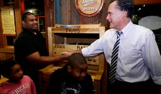 **FILE** Republican presidential candidate Mitt Romney greets customers Oct. 12, 2012, as he makes an unscheduled stop at City Barbeque in Gahanna, Ohio. (Associated Press)