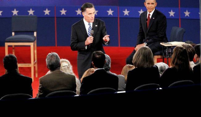 President Barack Obama, left, listens as Republican presidential candidate former Massachusetts Gov. Mitt Romney answers a question from a member of the audience. (AP Photo/Mary Altaffer)