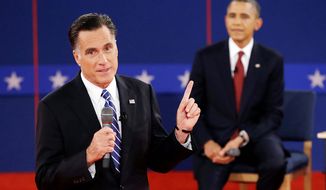 Republican presidential nominee Mitt Romney  answers a question as President Barack Obama listens during the second presidential debate. (AP Photo/Charlie Neibergall)