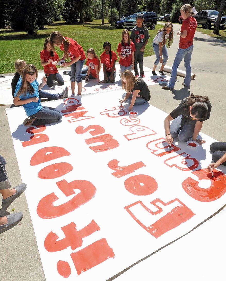 Cheerleaders at Kountze High School in Kountze, Texas, in September were told by district officials to stop using Bible verses at football games after the Freedom From Religion Foundation complained. Texas Attorney General Greg Abbott said on Wednesday, Oct. 17, 2012, that he will defend the cheerleaders. (Beaumont Enterprise via Associated Press)
