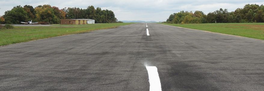 The runway at Grundy Municipal Airport is too short to comply with insurance standards for corporate jets, but federal regulators have refused to allow for an expansion without a mining permit because of the coal deposits below the land. (Debra McCown/Special to The Washington Times)