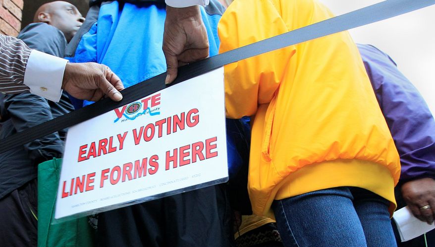 A sign lets people know where to line up for early voting at the Hamilton County Board of Elections in Cincinnati. Tough new election laws aimed at forcing voters in many states to show photo identification at polling places have been blocked or delayed, pleasing opponents who contend the laws were among a variety of partisan attempts to prevent minority voters from casting ballots this election season. (Associated Press)